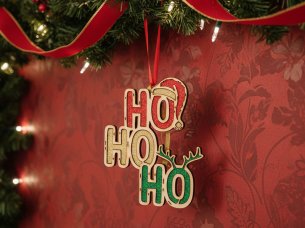 Laser Cut Ho Ho Ho Christmas Ornament Hanging on a Festive Garland